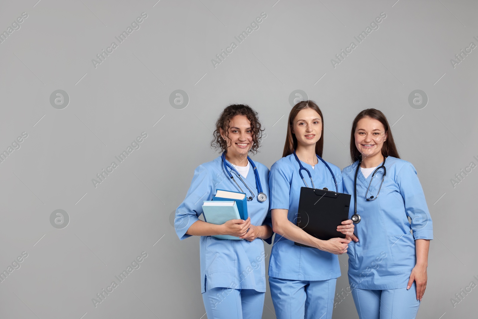 Group of medical students on light grey background. Space for text Photo of Group of medical students on light grey background. Space for text