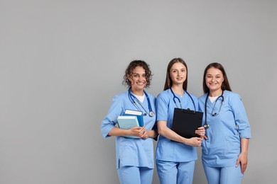 Photo of Group of medical students on light grey background. Space for text