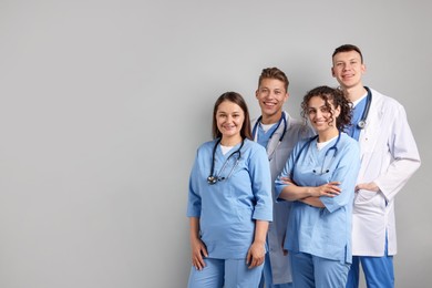 Photo of Group of medical students on light grey background. Space for text