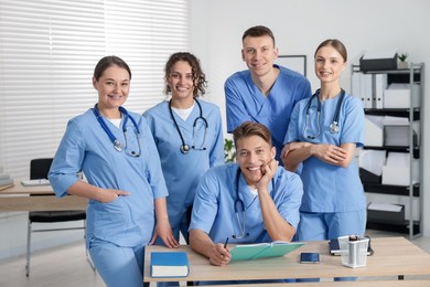 Photo of Medical students in uniforms studying together at university