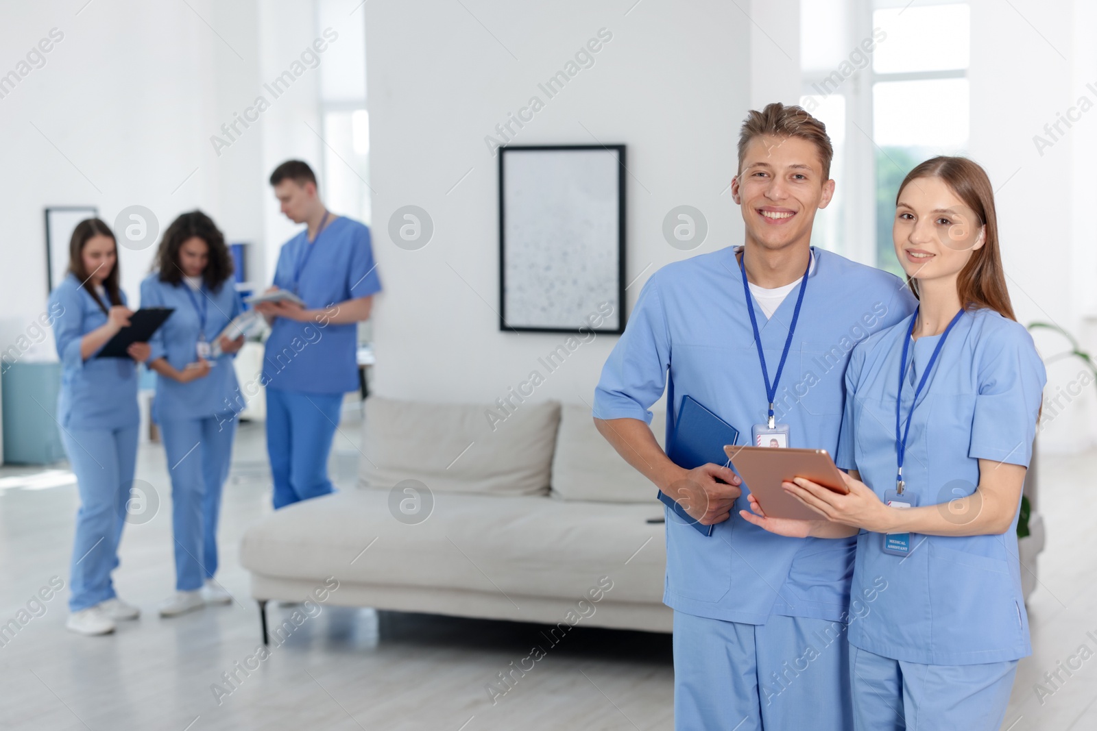 Medical students in uniforms indoors, selective focus Photo of Medical students in uniforms indoors, selective focus
