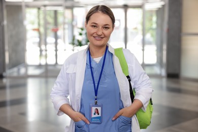 Photo of Medical student in uniform with backpack indoors