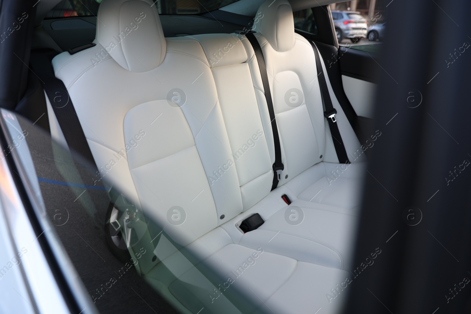 Modern car interior with seats and safety belts, view from outside Photo of Modern car interior with seats and safety belts, view from outside