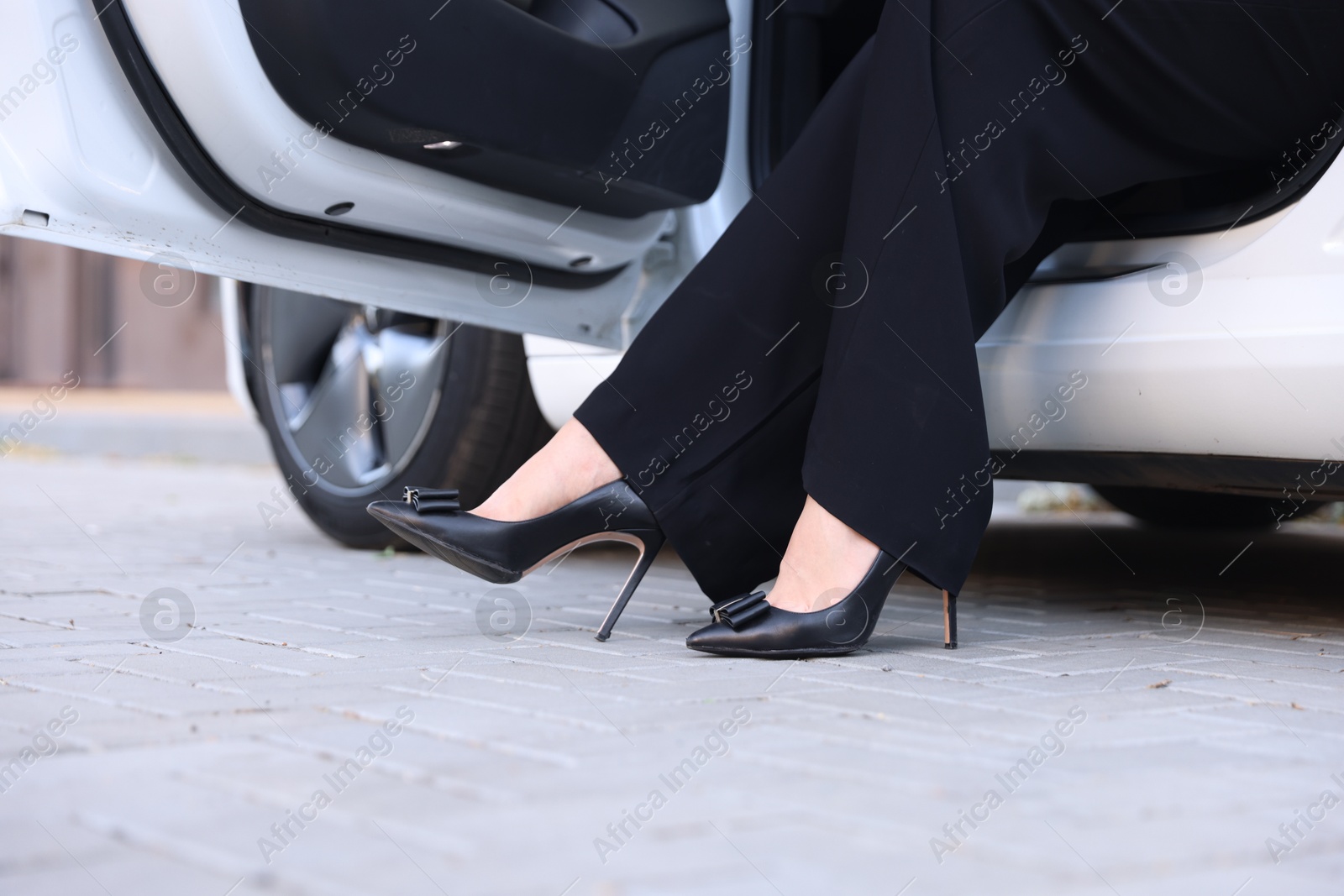 Woman getting out of modern car, closeup Photo of Woman getting out of modern car, closeup
