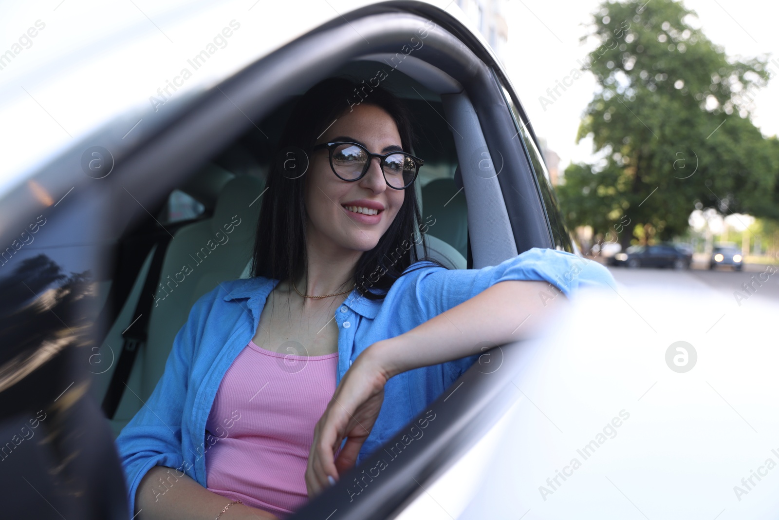 Woman in modern car, view from outside Photo of Woman in modern car, view from outside