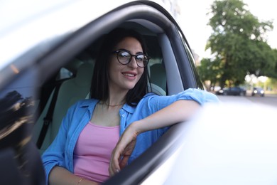 Photo of Woman in modern car, view from outside