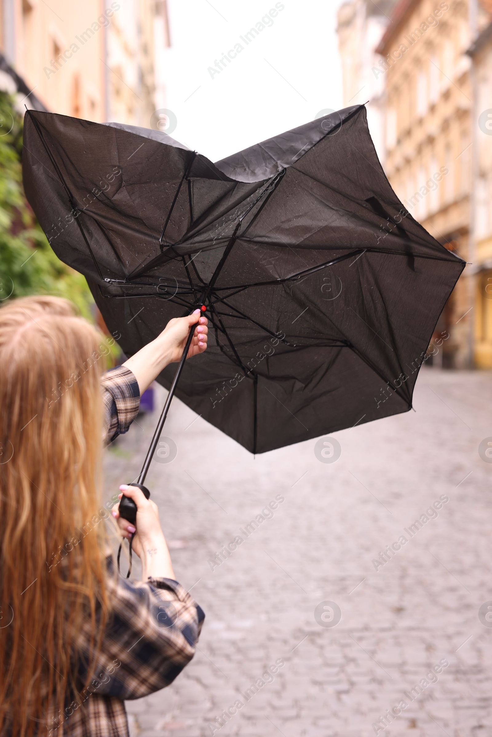 Woman with broken umbrella on city street, closeup Photo of Woman with broken umbrella on city street, closeup