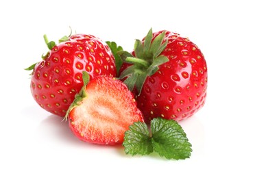 Photo of Fresh whole, cut strawberries and leaves isolated on white