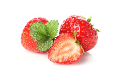 Photo of Fresh whole, cut strawberries and leaves isolated on white