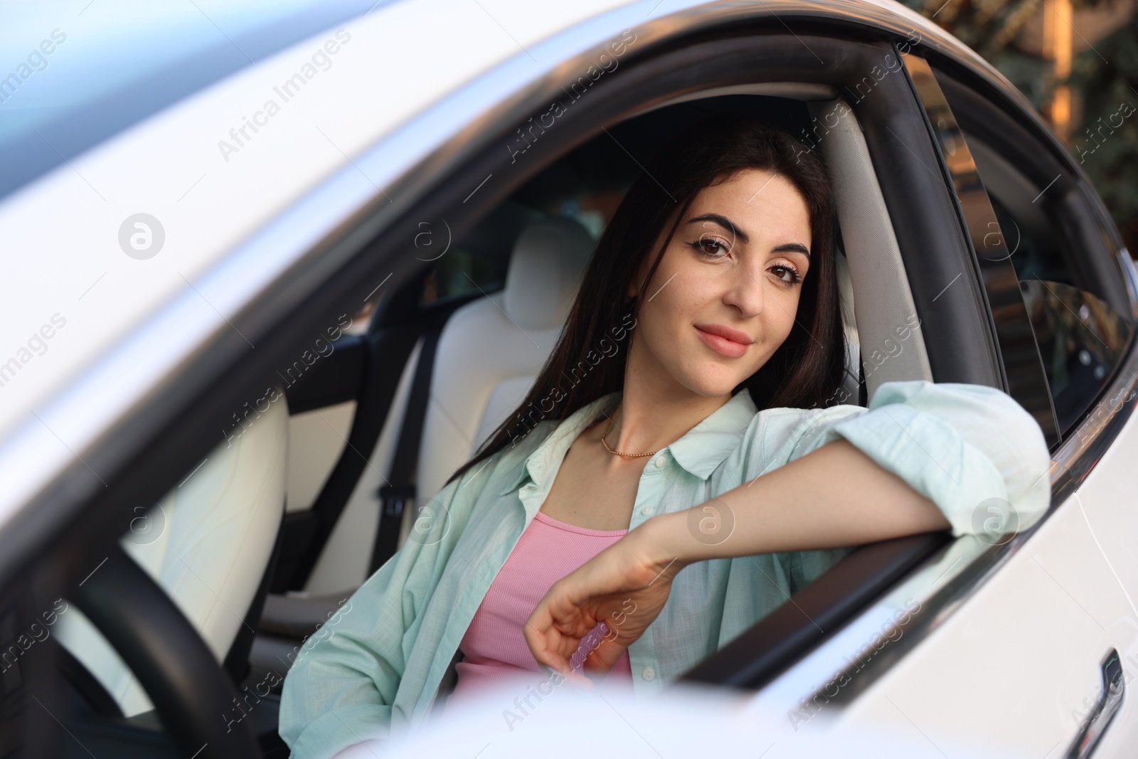 Woman sitting in modern car, view from outside Photo of Woman sitting in modern car, view from outside