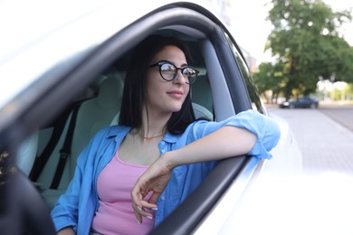 Photo of Woman in modern car, view from outside