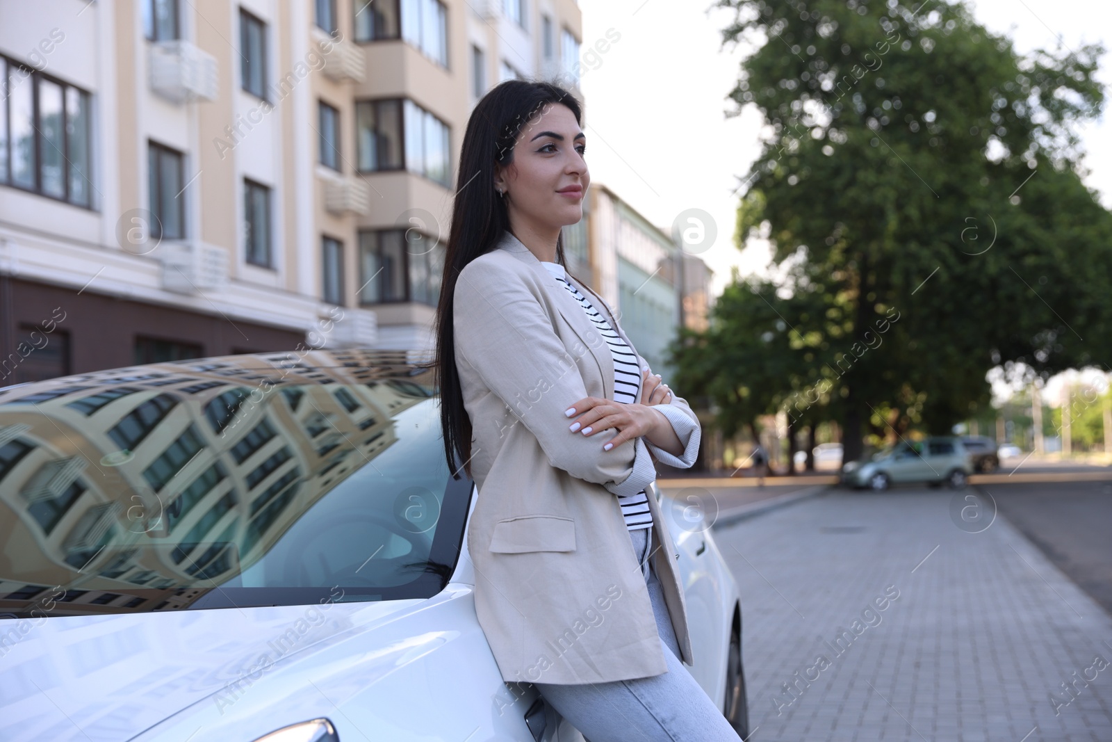 Beautiful woman near white car on city street Photo of Beautiful woman near white car on city street