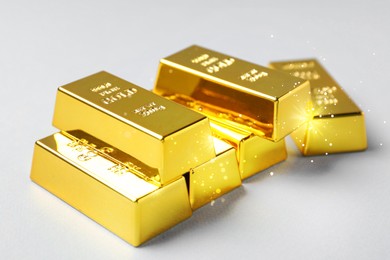 Image of Many shiny gold bars on white background