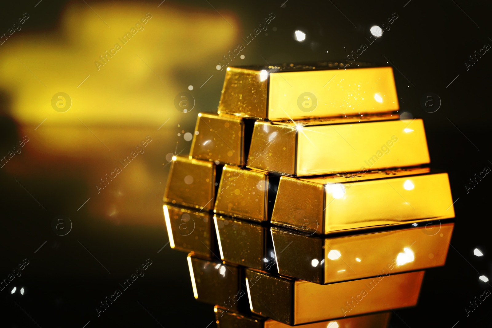 Stacked shiny gold bars on mirror surface. Space for text Image of Stacked shiny gold bars on mirror surface. Space for text