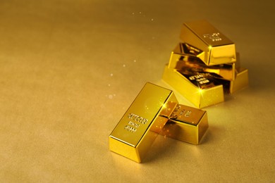 Image of Shiny gold bars on color background. Space for text