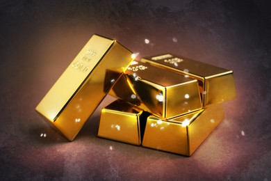 Image of Shiny gold bars on color textured background