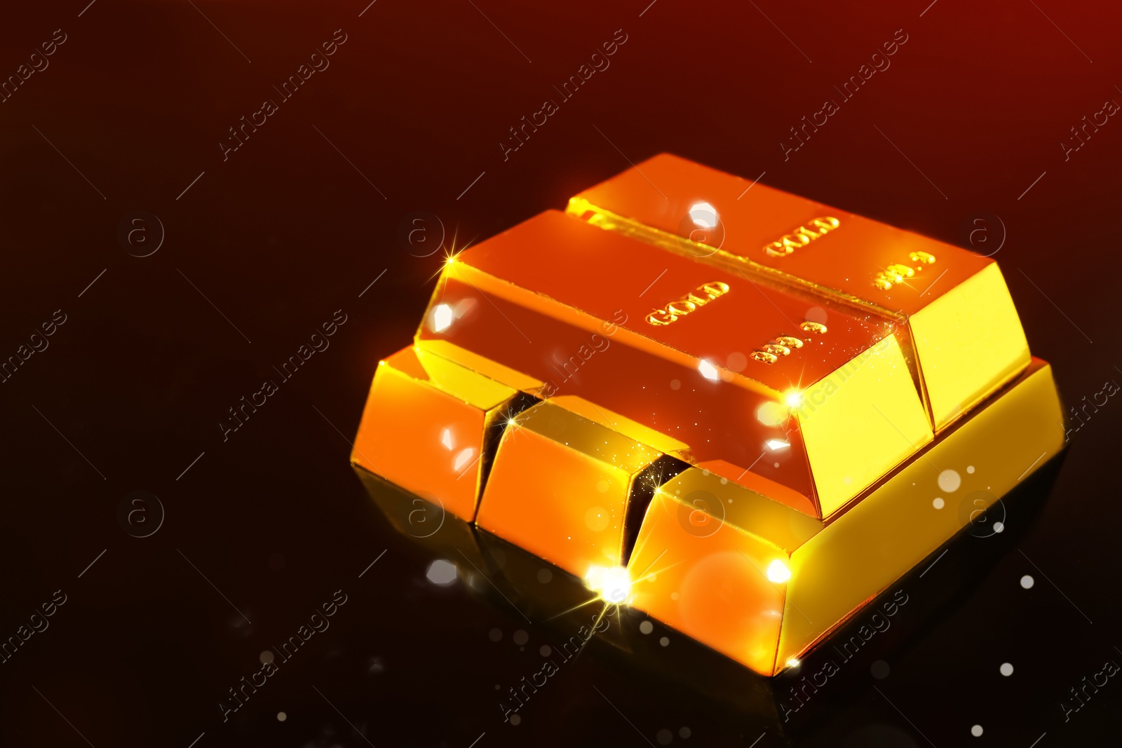 Shiny gold bars on red gradient black background. Space for text Image of Shiny gold bars on red gradient black background. Space for text