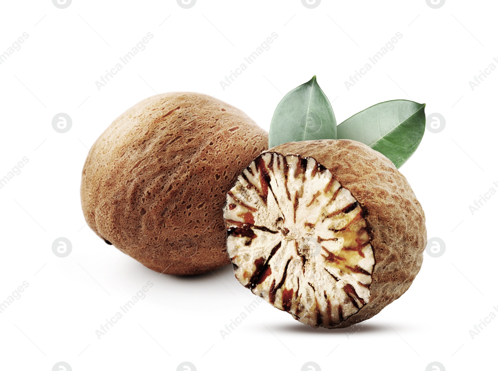Nutmeg seeds with green leaves on white background. Aromatic spice Image of Nutmeg seeds with green leaves on white background. Aromatic spice