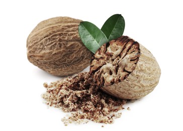 Image of Nutmeg seeds with green leaves on white background. Aromatic spice