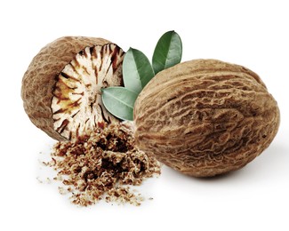 Image of Nutmeg seeds with green leaves on white background. Aromatic spice