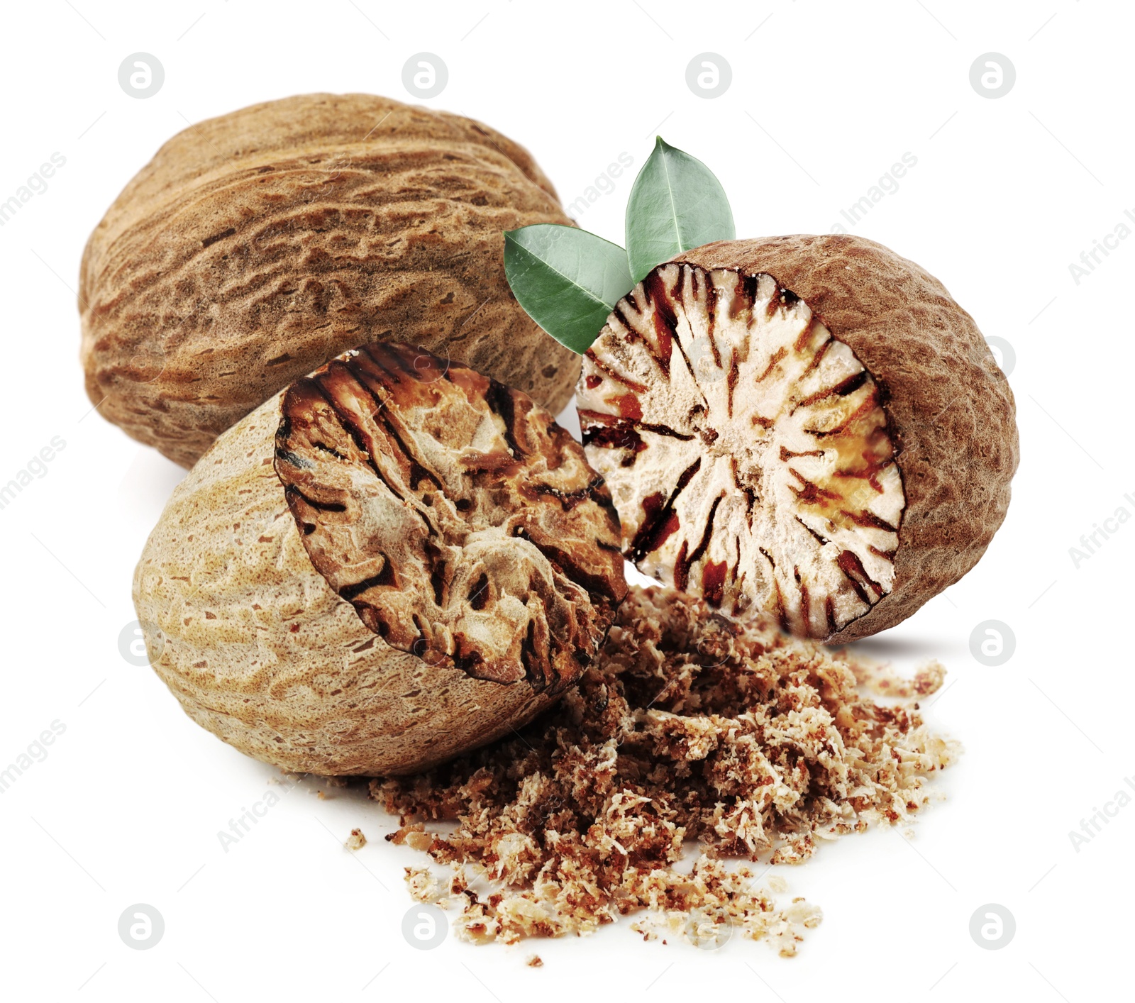Image of Nutmeg seeds with green leaves on white background. Aromatic spice