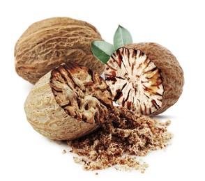 Image of Nutmeg seeds with green leaves on white background. Aromatic spice