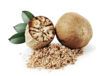 Image of Nutmeg seeds with green leaves on white background. Aromatic spice