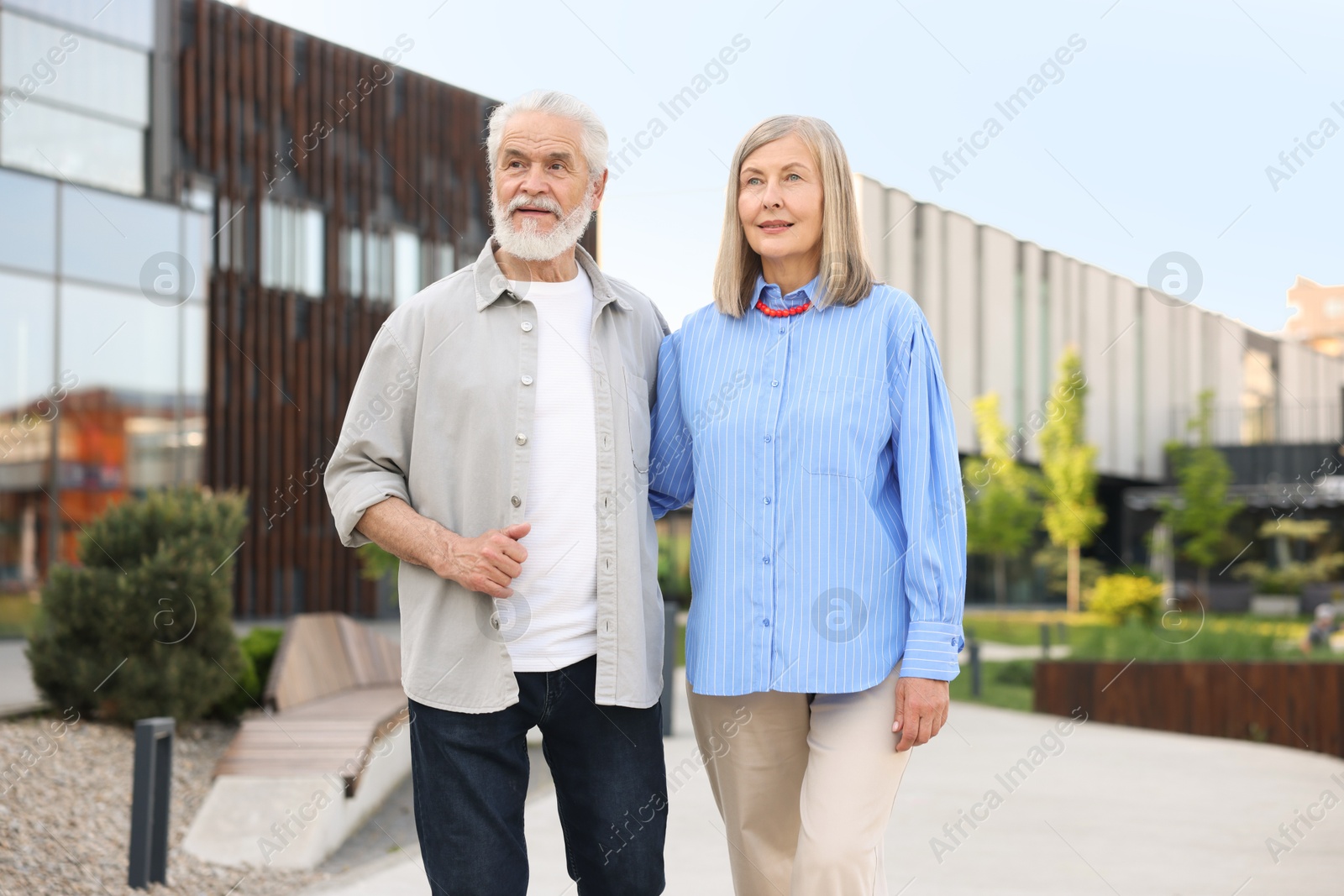 Lovely senior couple walking together on city street Photo of Lovely senior couple walking together on city street