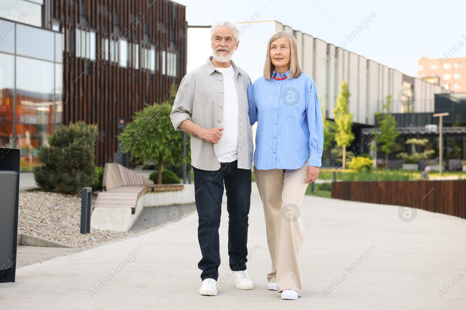 Lovely senior couple walking together on city street Photo of Lovely senior couple walking together on city street