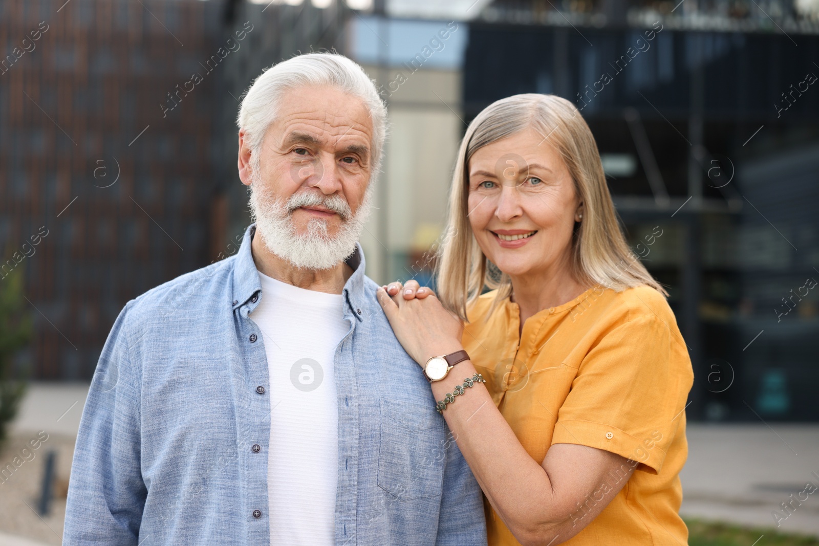 Lovely senior couple walking together on city street Photo of Lovely senior couple walking together on city street