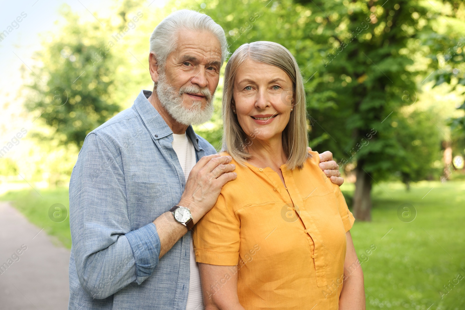 Lovely senior couple walking together in park Photo of Lovely senior couple walking together in park
