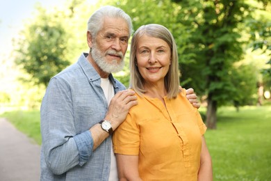 Photo of Lovely senior couple walking together in park
