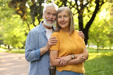 Photo of Lovely senior couple walking together in park