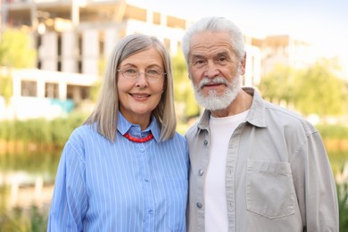 Photo of Lovely senior couple walking together in park