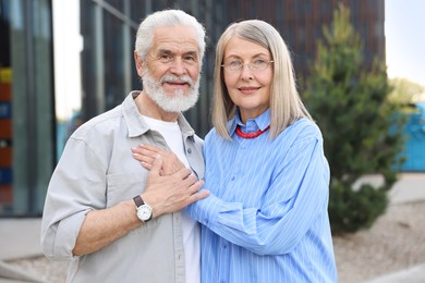 Photo of Lovely senior couple walking together in park