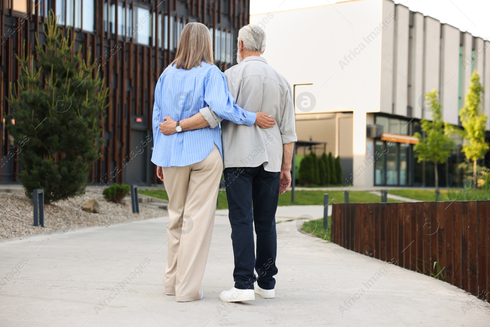 Lovely senior couple walking together in park, back view Photo of Lovely senior couple walking together in park, back view