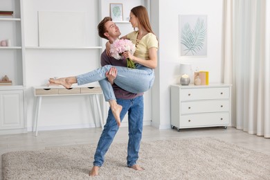 Photo of Happy young couple dancing together at home