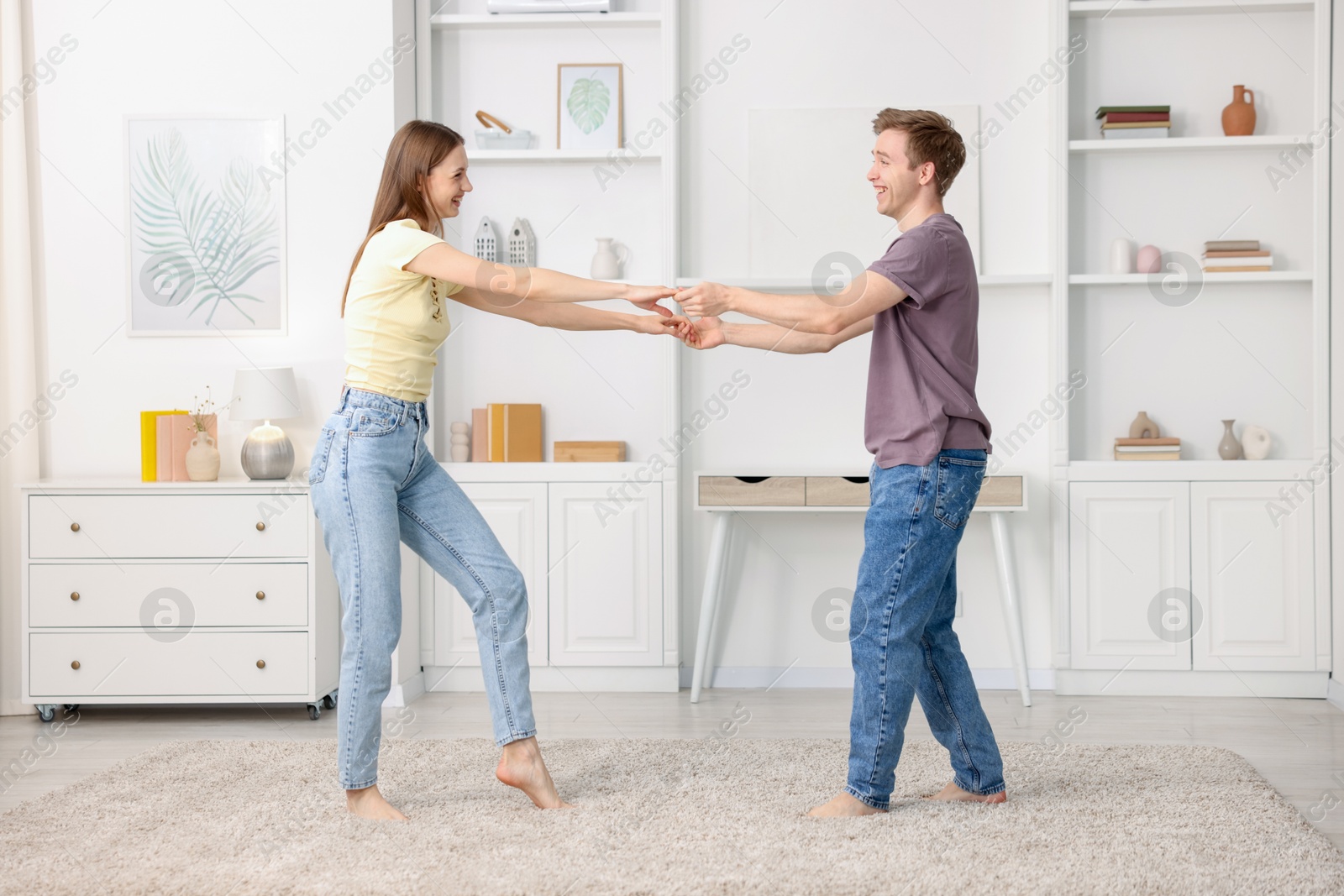 Happy young couple dancing together at home Photo of Happy young couple dancing together at home