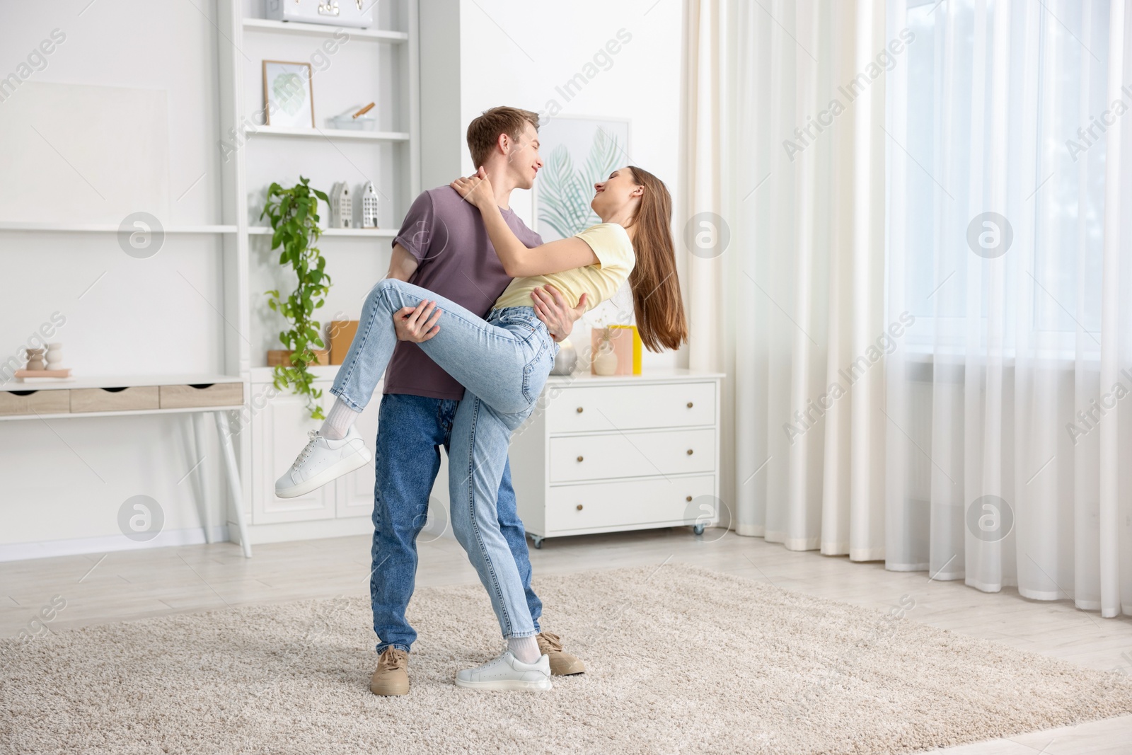 Happy young couple dancing together at home Photo of Happy young couple dancing together at home