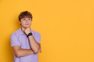Photo of Cute teenage boy on yellow background. Space for text