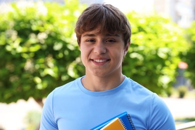 Photo of Portrait of smiling teenage boy on city street