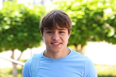 Photo of Portrait of smiling teenage boy on city street