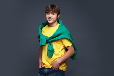 Photo of Portrait of smiling teenage boy on grey background