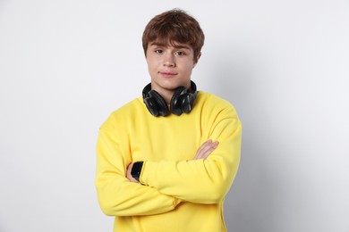 Photo of Portrait of teenage boy with crossed arms on light grey background