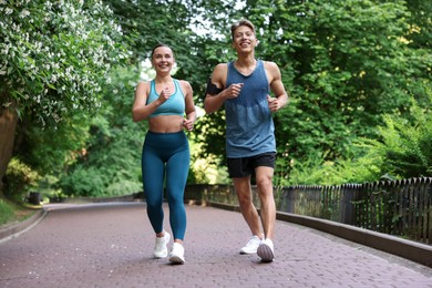 Photo of Sporty couple running in park. Healthy lifestyle