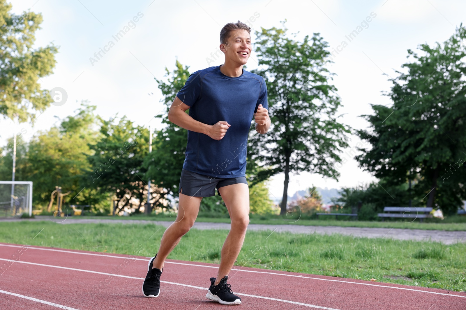 Sporty man running at stadium. Healthy lifestyle Photo of Sporty man running at stadium. Healthy lifestyle
