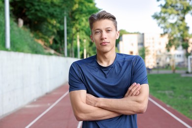 Photo of Portrait of happy sportsman at stadium. Healthy lifestyle