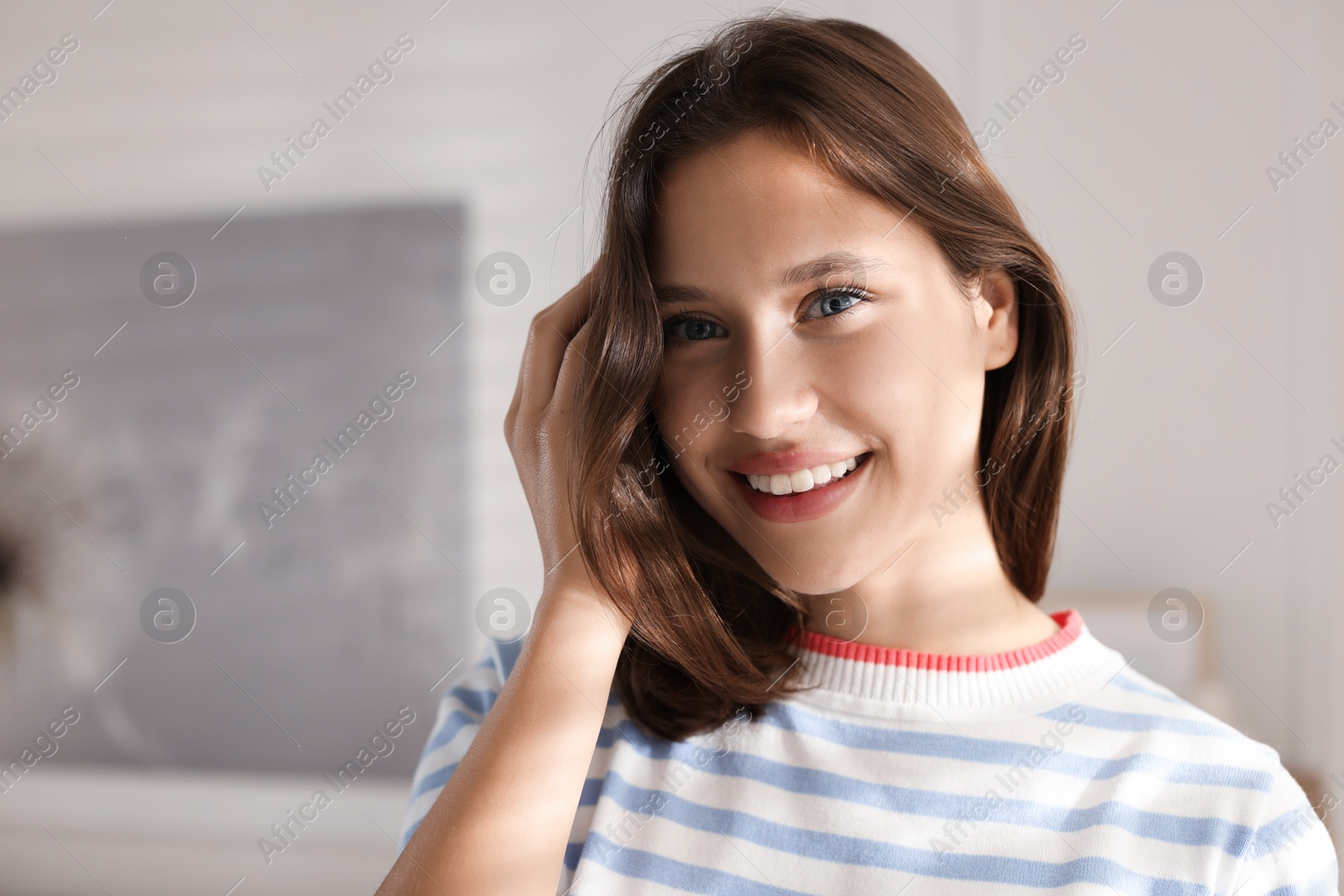 Portrait of smiling teenage girl at home Photo of Portrait of smiling teenage girl at home