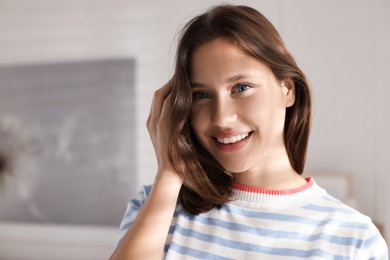 Photo of Portrait of smiling teenage girl at home