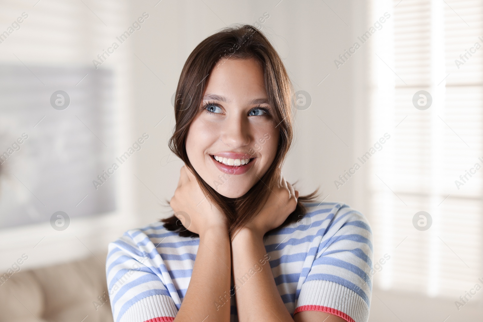 Portrait of smiling teenage girl at home Photo of Portrait of smiling teenage girl at home